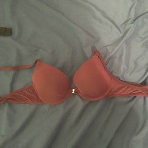 Maroon bra with white buttons on front